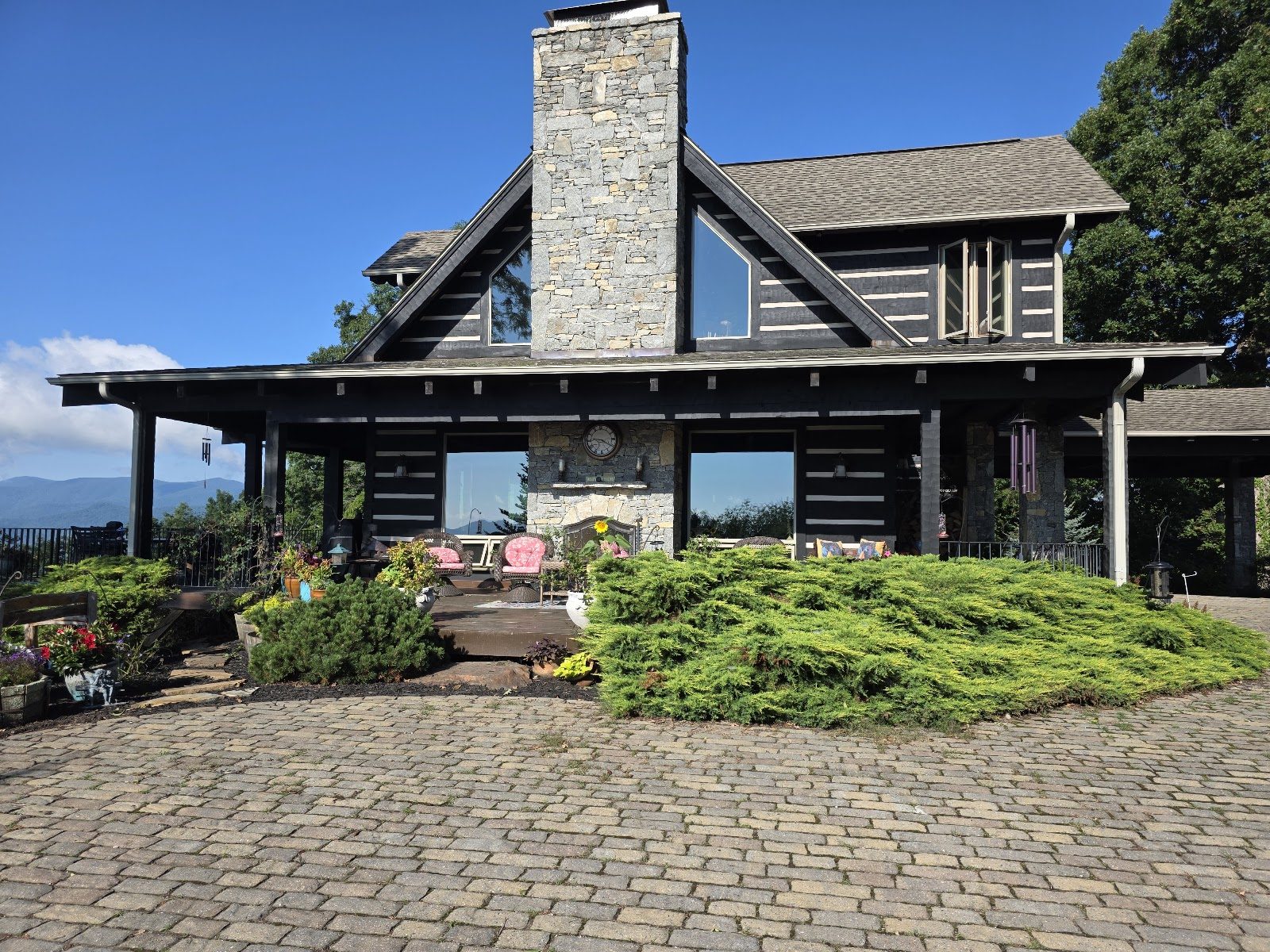 Trimmed landscaping in front of a log home
